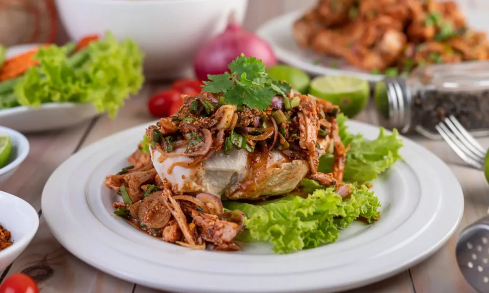 spicy-minced-chicken-white-plate-complete-with-cucumber-lettuce-side-dishes.